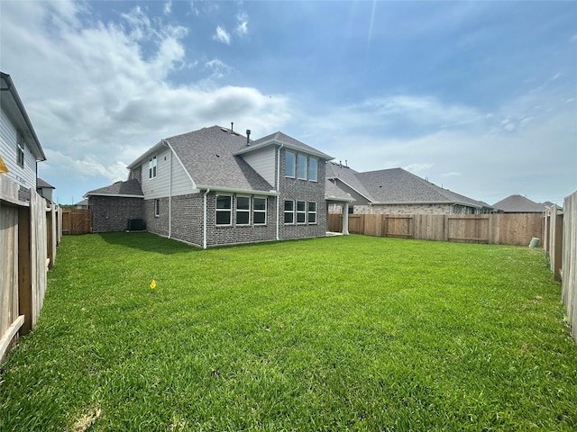 924 Wormwood Dr, League City, TX 77573 - rear view of house with roof with shingles, brick siding, and a fenced backyard