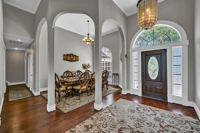 108 Somerton Dr, Montgomery, TX 77356 - entryway featuring a chandelier, arched walkways, healthy amount of natural light, dark wood-style flooring, and crown molding