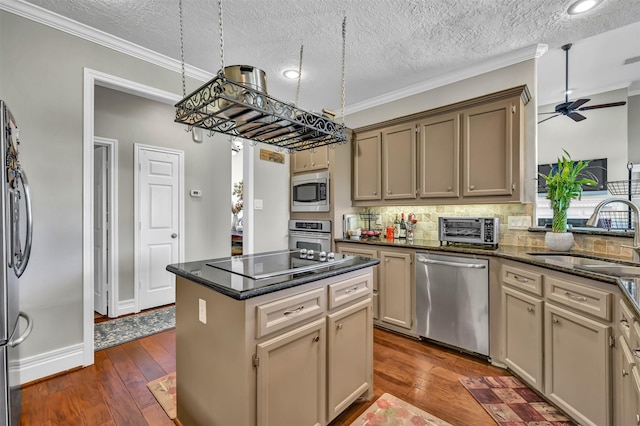 108 Somerton Dr, Montgomery, TX 77356 - kitchen featuring appliances with stainless steel finishes, a sink, ornamental molding, a kitchen island, and backsplash