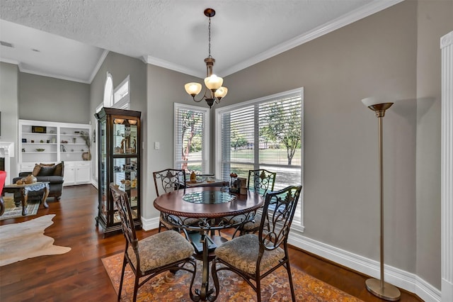 108 Somerton Dr, Montgomery, TX 77356 - dining area featuring dark wood-style floors, ornamental molding, baseboards, a chandelier, and a textured ceiling