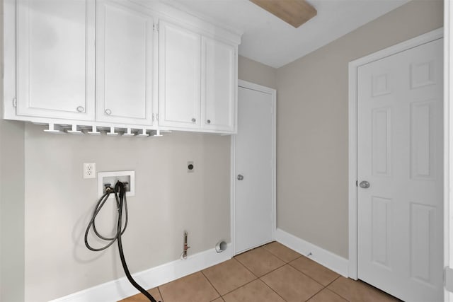 108 Somerton Dr, Montgomery, TX 77356 - laundry area with washer hookup, hookup for a gas dryer, cabinet space, electric dryer hookup, and light tile patterned floors