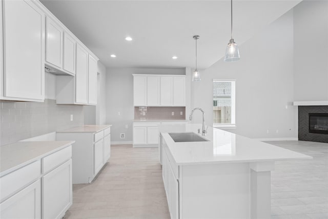 365 Spruce Oak Ln, Waller, TX 77484 - kitchen with a sink, recessed lighting, decorative backsplash, a kitchen island with sink, and open floor plan
