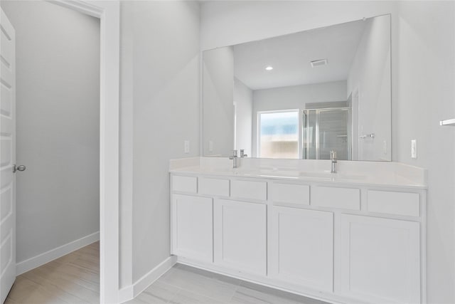 365 Spruce Oak Ln, Waller, TX 77484 - bathroom with a stall shower, baseboards, and double vanity