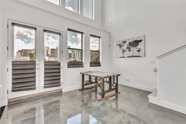 dining area featuring baseboards, concrete floors, and french doors
