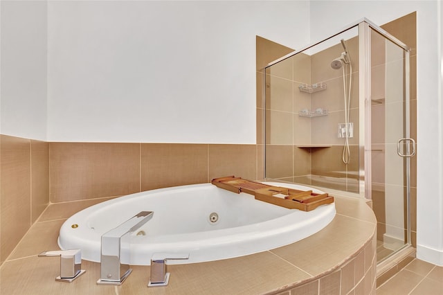 full bathroom featuring a stall shower, tile patterned floors, and a whirlpool tub