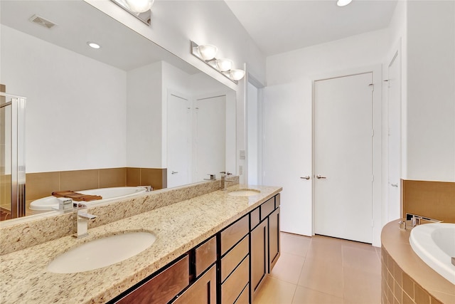 full bathroom with tile patterned floors, a sink, visible vents, double vanity, and a bath