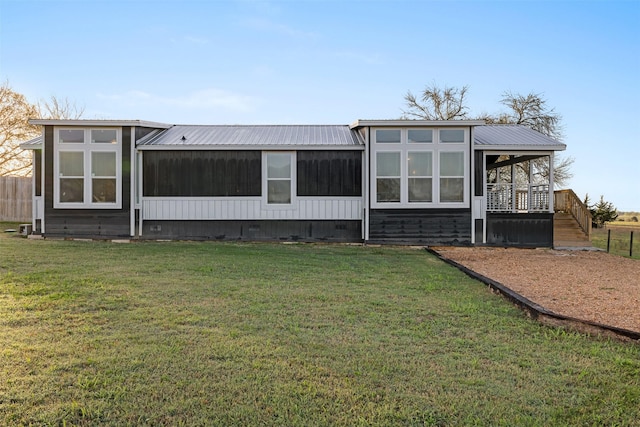 1731 Spur 458, Carmine, TX 78932 - back of property featuring crawl space, metal roof, stairway, and a lawn