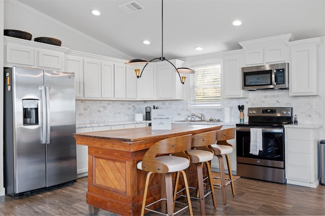 1731 Spur 458, Carmine, TX 78932 - kitchen with appliances with stainless steel finishes, light countertops, dark wood-style floors, recessed lighting, and crown molding