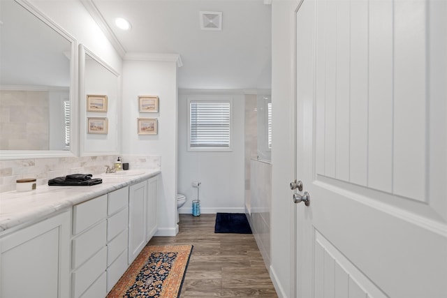 1731 Spur 458, Carmine, TX 78932 - bathroom with vanity, toilet, ornamental molding, wood finished floors, and backsplash