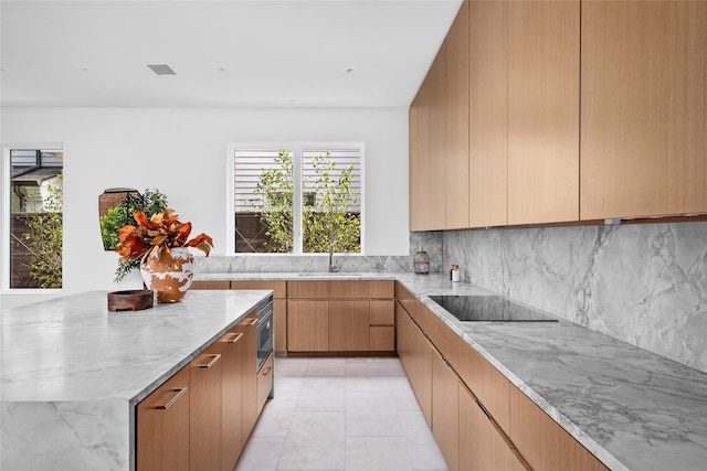 2215 Albans Rd, Houston, TX 77005 - kitchen with black electric cooktop, light stone counters, decorative backsplash, a sink, and modern cabinets