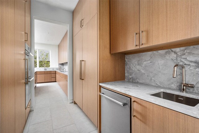 2215 Albans Rd, Houston, TX 77005 - kitchen with modern cabinets, stainless steel appliances, a sink, backsplash, and light stone countertops