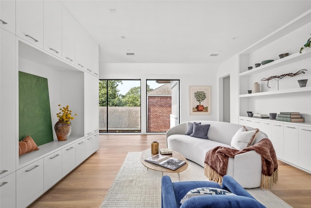 2215 Albans Rd, Houston, TX 77005 - living room with light wood-style floors and built in shelves