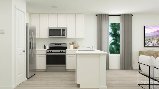 kitchen featuring stainless steel appliances, light wood finished floors, a sink, white cabinets, and light countertops