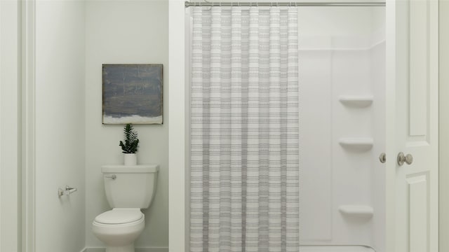full bath with a shower with shower curtain and toilet