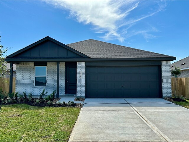 ranch-style home with brick siding, concrete driveway, an attached garage, board and batten siding, and a shingled roof