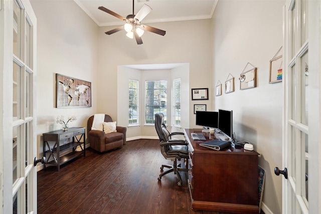 office area with french doors, a ceiling fan, a high ceiling, dark wood-type flooring, and ornamental molding