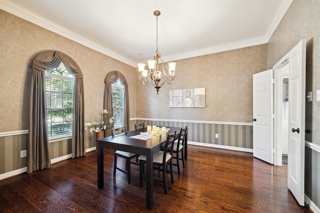 dining area featuring wood finished floors, crown molding, baseboards, arched walkways, and a chandelier