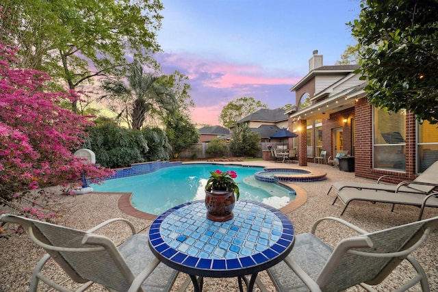 view of swimming pool featuring a fenced backyard, a patio, outdoor dining area, and a pool with connected hot tub