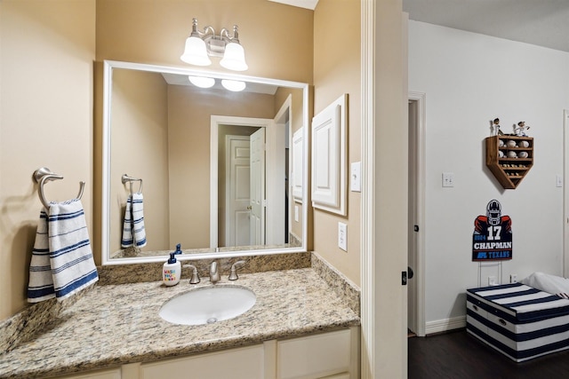 bathroom with vanity and wood finished floors