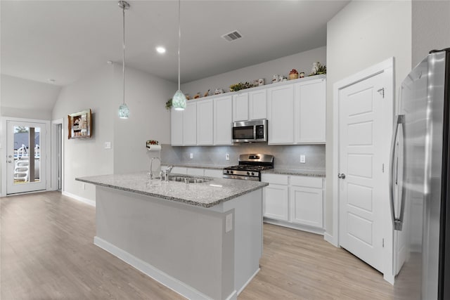 119 Comber Rd, Magnolia, TX 77354 - kitchen featuring a sink, white cabinetry, appliances with stainless steel finishes, light wood-style flooring, and visible vents