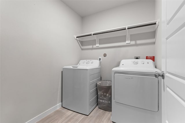 119 Comber Rd, Magnolia, TX 77354 - laundry area featuring baseboards, laundry area, washer and clothes dryer, and light wood finished floors