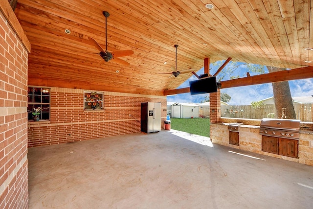 9926 Caffrey St, Houston, TX 77075 - view of patio with exterior kitchen, a shed, an outbuilding, ceiling fan, and fence