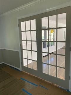 5535 Spellman Rd, Houston, TX 77096 - doorway featuring a healthy amount of sunlight and crown molding