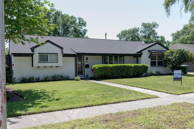 5535 Spellman Rd, Houston, TX 77096 - ranch-style house with a front lawn, roof with shingles, and brick siding