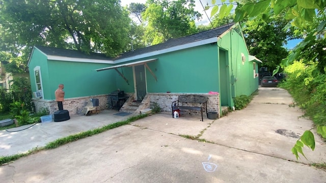 8145 Homewood Ln, Houston, TX 77028 - view of property exterior featuring a patio area and stucco siding