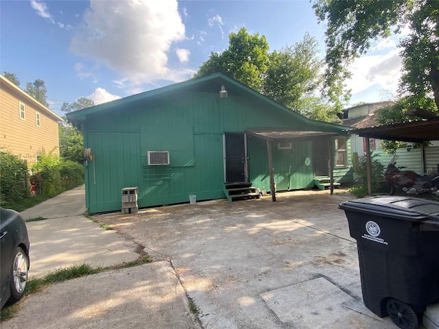 8145 Homewood Ln, Houston, TX 77028 - view of outbuilding with entry steps, a carport, and driveway