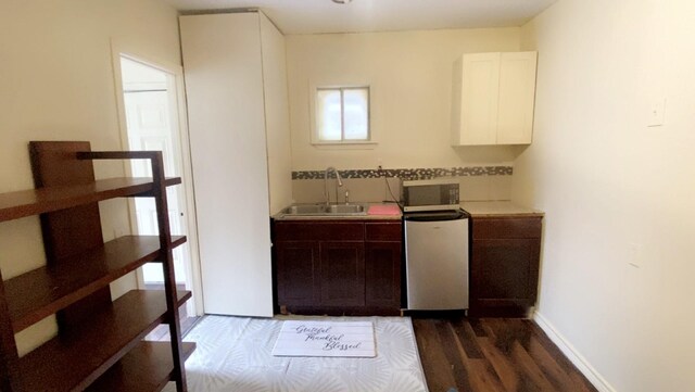 8145 Homewood Ln, Houston, TX 77028 - kitchen featuring a sink, light countertops, dark wood finished floors, backsplash, and range
