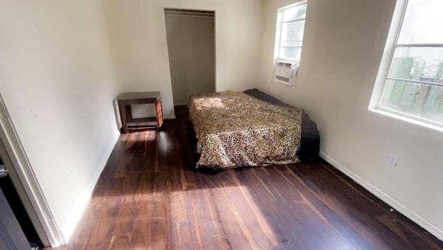 8145 Homewood Ln, Houston, TX 77028 - bedroom with dark wood-style flooring, baseboards, and cooling unit
