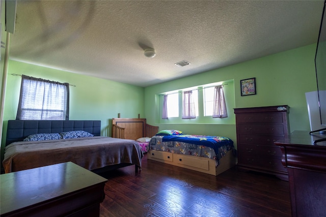 18531 Grove Brook Ln, Cypress, TX 77429 - bedroom featuring dark wood-style flooring and a textured ceiling