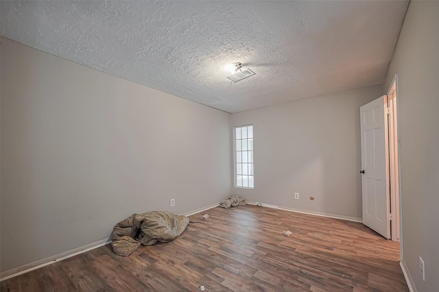 811 Loire Ln, Houston, TX 77090 - spare room with a textured ceiling, baseboards, and wood finished floors