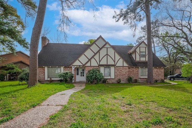 811 Loire Ln, Houston, TX 77090 - english style home featuring stucco siding, brick siding, a front lawn, and roof with shingles