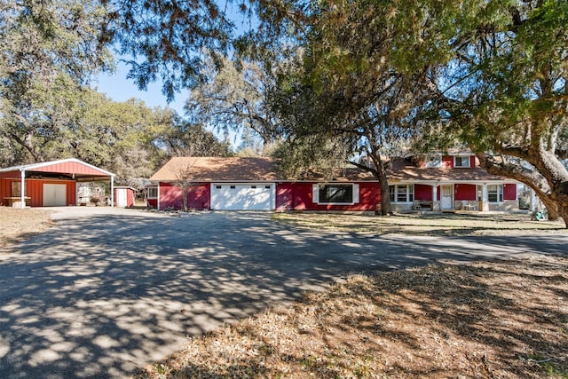 1473 County Road 411, Uvalde, TX 78801 - view of front facade with driveway, covered porch, and a detached carport