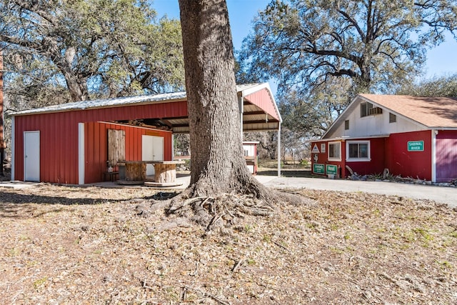 1473 County Road 411, Uvalde, TX 78801 - view of side of property with a pole building and an outbuilding