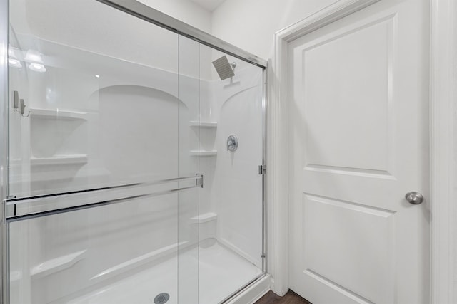 full bath featuring a shower stall