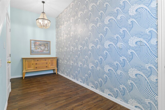 2102 Avenue N Ave N, Galveston, TX 77550 - empty room featuring dark wood-type flooring, baseboards, an inviting chandelier, and wallpapered walls
