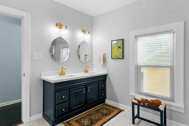2102 Avenue N Ave N, Galveston, TX 77550 - bathroom with baseboards, double vanity, and a sink