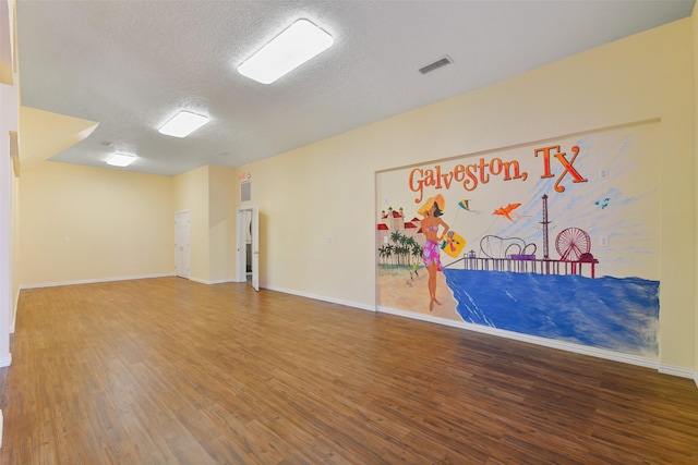 2102 Avenue N Ave N, Galveston, TX 77550 - unfurnished room with wood finished floors, a textured ceiling, baseboards, and visible vents