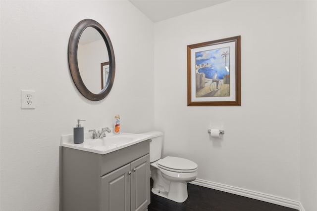 2102 Avenue N Ave N, Galveston, TX 77550 - half bathroom with baseboards, toilet, vanity, and wood finished floors