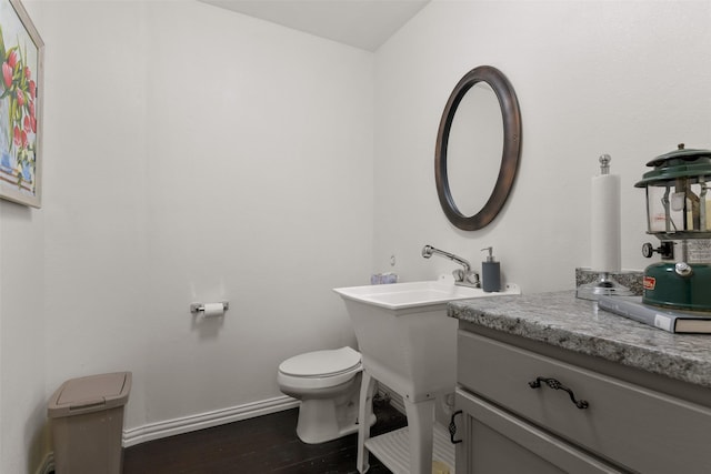 2102 Avenue N Ave N, Galveston, TX 77550 - half bathroom featuring toilet, wood finished floors, and baseboards
