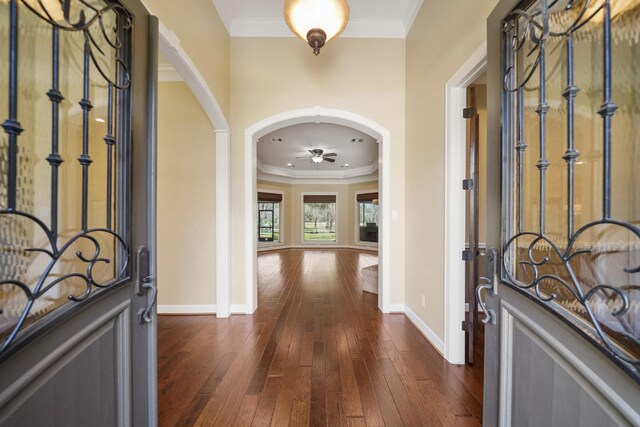 33922 High Point Dr, Magnolia, TX 77355 - foyer entrance with ornamental molding, arched walkways, dark wood-style floors, and a ceiling fan