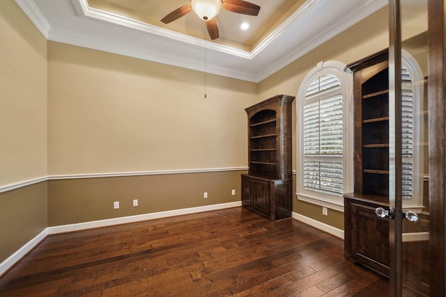 33922 High Point Dr, Magnolia, TX 77355 - empty room featuring a raised ceiling, ceiling fan, dark wood-type flooring, and ornamental molding
