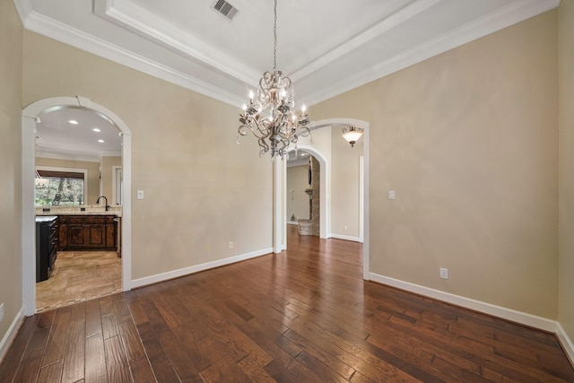 33922 High Point Dr, Magnolia, TX 77355 - unfurnished room featuring arched walkways, dark wood finished floors, crown molding, and a chandelier