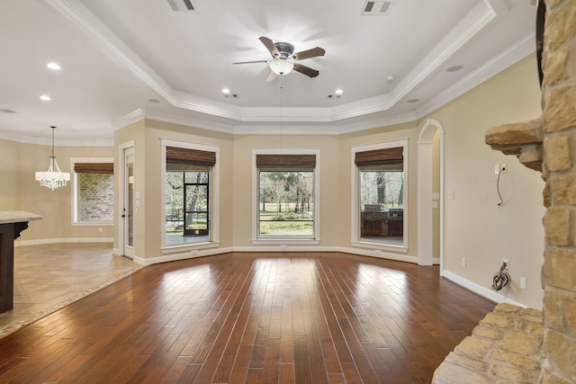 33922 High Point Dr, Magnolia, TX 77355 - unfurnished living room featuring ceiling fan, hardwood / wood-style floors, a raised ceiling, and crown molding