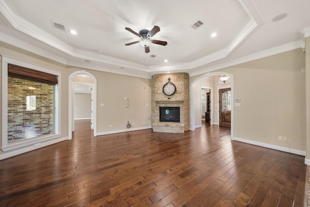 33922 High Point Dr, Magnolia, TX 77355 - unfurnished living room featuring arched walkways, ceiling fan, a stone fireplace, plenty of natural light, and ornamental molding