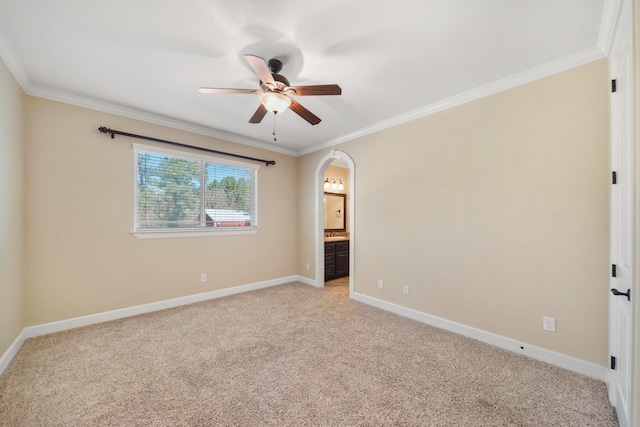 33922 High Point Dr, Magnolia, TX 77355 - unfurnished bedroom featuring light carpet, crown molding, arched walkways, and baseboards
