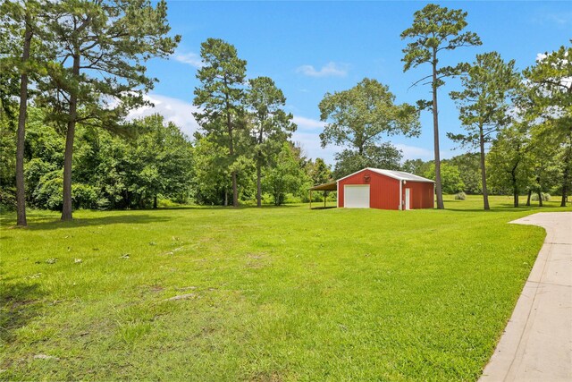 33922 High Point Dr, Magnolia, TX 77355 - view of green lawn featuring a garage, an outbuilding, driveway, and a pole building